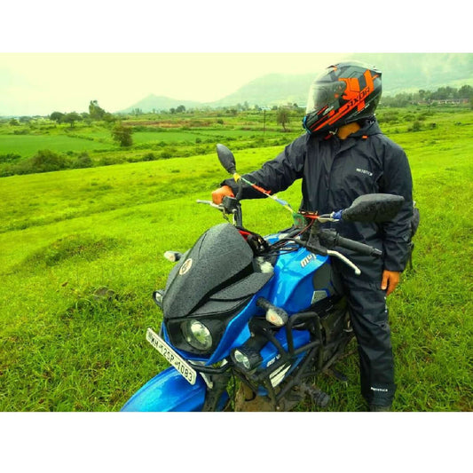 MotoTech Hurricane Rain Overjacket review – rider on motorcycle in rain gear on a green landscape
